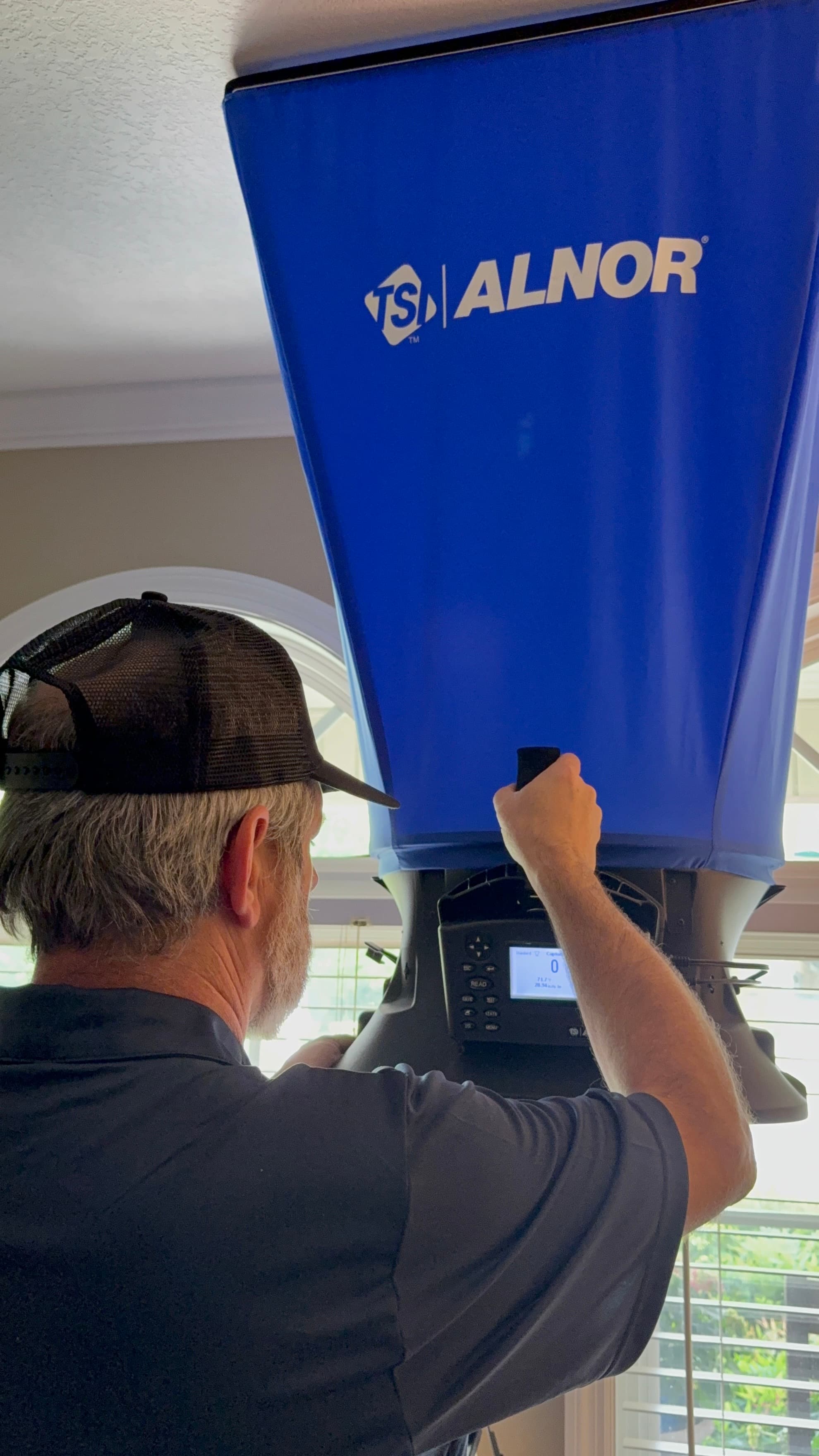 Russell measuring airflow during a Comfort Club membership visit