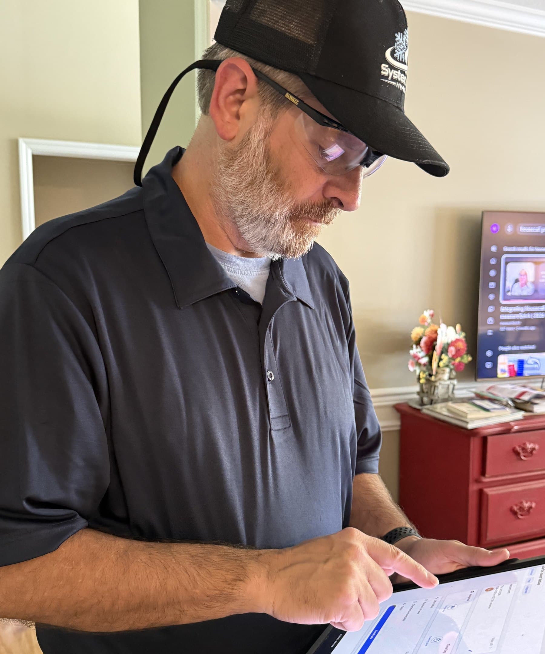 Russell recording readings on a tablet during a maintenance visit